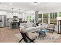 Open-concept living space featuring a seamless transition from the kitchen to the living room at 181 Montgomery Pl # 726, Mount Gilead, NC 27306