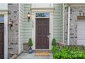 Charming front door with manicured bushes and a 'hello' welcome mat at 1849 Fleetwood Dr, Charlotte, NC 28208