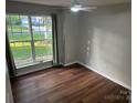 Bright bedroom with hardwood floors, neutral walls, and a large window with outdoor views at 1863 New Castle Dr, Fort Mill, SC 29707