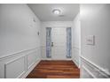 Welcoming entryway featuring pristine white walls, wood floors, and elegant wainscoting at 1863 New Castle Dr, Fort Mill, SC 29707