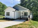 Charming home exterior with a welcoming front porch and well-manicured landscaping at 1889 Oak Hollow Rd, Gastonia, NC 28054