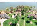 Expansive aerial shot of a lakeside property with a well-maintained lawn, mature trees, and waterfront access at 202 Timber Lake Dr, Troutman, NC 28166