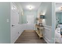 Inviting entryway with light blue walls, complemented by wood floors and tasteful decor at 2124 Katie Alice Cir, Waxhaw, NC 28173