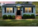 Charming home boasts fresh exterior paint, updated front porch and well-maintained landscaping at 232 Avery St, Fort Mill, SC 29715
