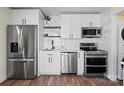 Modern kitchen with stainless steel appliances, white cabinets, and a stylish backsplash at 232 Avery St, Fort Mill, SC 29715