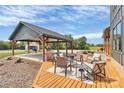 Outdoor living space featuring a covered patio with comfortable seating and a grill area at 25674 Old School Rd, Oakboro, NC 28129