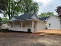 Charming home featuring a covered front porch and a new wooden deck for outdoor enjoyment at 300 Kelly St, Statesville, NC 28677