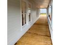 Inviting front porch featuring a newly finished wooden floor and stylish white railing at 300 Kelly St, Statesville, NC 28677