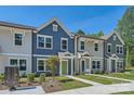 A row of lovely townhomes boasts colorful exteriors, lush lawns, and inviting walkways at 3015 Howell Mill Rd, Charlotte, NC 28208