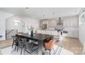 Open kitchen with a large island, stainless steel appliances, and elegant dining area at 302 Wesley Heights Way, Charlotte, NC 28208