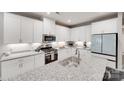 Modern kitchen featuring white cabinets, stainless steel appliances, and granite countertops at 306 Willow Wood Ct, Matthews, NC 28104