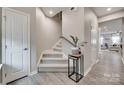 Carpeted staircase with wooden handrail and gray walls leading to the upper level at 306 Willow Wood Ct, Matthews, NC 28104
