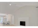 Bright living room featuring a fireplace and vaulted ceilings, adjacent to the dining area at 308 Southland Rd, Huntersville, NC 28078