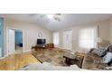 Bright living room with hardwood flooring, neutral walls, and a decorative area rug at 3124 Banks St, Lincolnton, NC 28092