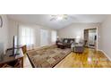 Cozy living room features hardwood floors, vaulted ceilings, and a decorative area rug at 3124 Banks St, Lincolnton, NC 28092