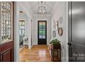 Inviting entryway featuring hardwood floors, stylish light fixtures, and tasteful decor, creating a warm ambiance at 327 Kenway Loop, Mooresville, NC 28117