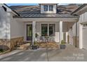 Charming front porch with stone accents, seating area, and a welcoming entrance to the home at 327 Kenway Loop, Mooresville, NC 28117