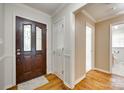 Elegant foyer with hardwood floors, decorative front door and neutral paint scheme at 4307 Edgeland Rd, Edgemoor, SC 29712