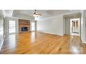 Spacious living room with hardwood floors, brick fireplace, and trey ceilings at 4307 Edgeland Rd, Edgemoor, SC 29712