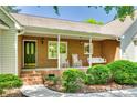Inviting brick porch with rocking chairs and a swing, perfect for relaxation and enjoying the outdoors at 4307 Edgeland Rd, Edgemoor, SC 29712