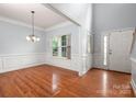 Bright dining room featuring hardwood floors, a classic chandelier, and ample natural light at 461 Pier Point Nw Ct, Concord, NC 28027