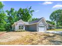 Stylish home with a two-car garage, landscaped lawn, and modern exterior design on a sunny day at 503 Eddleman Rd, Kannapolis, NC 28083