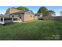 Spacious backyard with a well-maintained lawn, deck, hot tub, and privacy fence at 5050 Forest Ridge Dr, Hickory, NC 28602