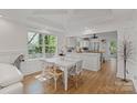 Bright dining room with a large window, modern lighting, and hardwood floors at 56 Blume Sw Ave, Concord, NC 28025