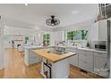 Bright open kitchen with white cabinets, butcher block island, stainless appliances, and hardwood floors at 56 Blume Sw Ave, Concord, NC 28025