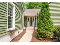Close-up of the home's entrance with a well-manicured garden and inviting doorway at 5916 Rexwood Pl, Charlotte, NC 28210