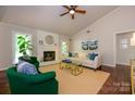 Bright living room featuring a painted fireplace, hardwood floors, and vaulted ceilings at 5916 Rexwood Pl, Charlotte, NC 28210