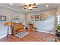 Elegant living room with hardwood floors, ceiling fan, and stylish decor offers a comfortable gathering space at 604 Airport Rd, Kannapolis, NC 28081