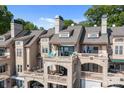 Multi-story home featuring a patio, balconies, awnings, and scenic views for upscale living at 657 Portside Dr, Davidson, NC 28036