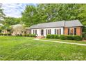 Charming one-story home with white siding, black shutters, and lush green lawn at 6718 Summerlin Pl, Charlotte, NC 28226