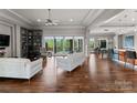 Spacious living room with hardwood floors, modern furnishings, and expansive glass doors leading to the outside at 767 Pinnacle Dr, Iron Station, NC 28080