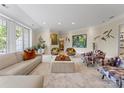 Bright living room featuring stylish furniture and natural light from large windows at 974 Queens Rd, Charlotte, NC 28207