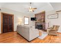 Cozy living room featuring a brick fireplace, hardwood floors, and comfortable seating at 10139 Arlington Church Rd, Mint Hill, NC 28227