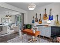 Stylish home office featuring a modern desk, guitars on the wall, and an adjacent sitting room at 106 Wrangler Dr, Mooresville, NC 28115
