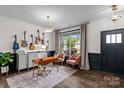 Inviting home office with guitars adorning the wall, featuring a desk, and comfortable seating at 106 Wrangler Dr, Mooresville, NC 28115