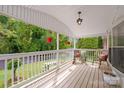 Inviting covered front porch with charming decor and scenic views of the landscaped front yard at 1106 3Rd Sw Ave, Hickory, NC 28602