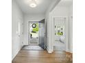 Bright entryway with hardwood floors and views of the front yard and bedroom at 1116 Brooksland Pl, Waxhaw, NC 28173