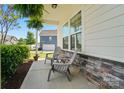 Cozy porch with seating, perfect for relaxing and enjoying the neighborhood view at 1116 Brooksland Pl, Waxhaw, NC 28173