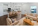 Bright, open-concept living space with modern furnishings and hardwood floors at 11933 Silverheel Ln, Huntersville, NC 28078