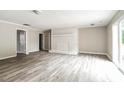 Open living area with light gray walls, wood-look flooring, and a decorative white brick fireplace at 1204 Glenarden Dr, Rock Hill, SC 29730