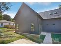 Modern home featuring a metal roof and landscaped grounds with a concrete patio at 122 Laura Rd # B, Mooresville, NC 28117