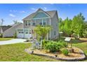 Two-story home featuring manicured landscaping and garden beds at 13408 Portside Ln, Lancaster, SC 29720