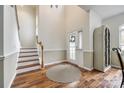 Bright foyer with hardwood floors, staircase, and a stylish decorative cabinet at 1418 Lonan Dr, Waxhaw, NC 28173