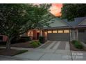 Inviting home exterior boasting a well-kept lawn, brick-lined driveway, and charming front porch at 142 Aztec Cir, Mooresville, NC 28117