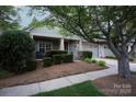 Inviting exterior with a well-kept lawn, charming front porch, and attached two-car garage at 142 Aztec Cir, Mooresville, NC 28117