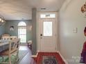 Inviting entryway featuring wood floors and decorative glass door welcomes you into the home at 1715 Colin Creek Ln, Charlotte, NC 28214